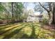 Large, private backyard with a fence, lush grass, and mature trees at 11100 Pine Grove Ave, Mint Hill, NC 28227