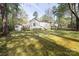 Large fenced backyard with lush green grass and a detached garage at 11100 Pine Grove Ave, Mint Hill, NC 28227