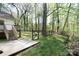 Wooden stairs lead down to a concrete patio and grassy backyard, and a fence lining the edge at 11100 Pine Grove Ave, Mint Hill, NC 28227