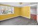 This sunny bedroom has a window, light-grey flooring, and access to another room at 11100 Pine Grove Ave, Mint Hill, NC 28227