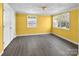 This sunny bedroom has two windows, light-grey flooring, and a spacious closet at 11100 Pine Grove Ave, Mint Hill, NC 28227