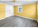 This sunny bedroom has one window, light-grey flooring, and a spacious closet at 11100 Pine Grove Ave, Mint Hill, NC 28227