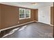 This cozy bedroom features two bright windows, a spacious closet, and sleek wood-look flooring at 11100 Pine Grove Ave, Mint Hill, NC 28227