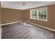 The bedroom features two windows with bright, natural light and vinyl flooring at 11100 Pine Grove Ave, Mint Hill, NC 28227