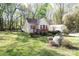 View of the house featuring a detached garage and fenced yard with lush green grass at 11100 Pine Grove Ave, Mint Hill, NC 28227