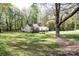 Home with large trees and lush green lawn and a detached garage at 11100 Pine Grove Ave, Mint Hill, NC 28227
