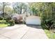 Detached two-car garage with a large concrete driveway and mature trees at 11100 Pine Grove Ave, Mint Hill, NC 28227