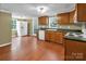 Well-lit kitchen with ample cabinet space, white appliances, and views from multiple windows at 11100 Pine Grove Ave, Mint Hill, NC 28227