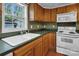 Kitchen featuring matching appliances, generous counter space, and a bright sink area at 11100 Pine Grove Ave, Mint Hill, NC 28227