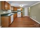 Functional kitchen featuring ample cabinetry, white appliances and generous counter space at 11100 Pine Grove Ave, Mint Hill, NC 28227