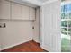 Efficient laundry room with storage cabinets and a window, offering practicality and natural light at 11100 Pine Grove Ave, Mint Hill, NC 28227