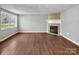Inviting living room featuring hardwood floors and a cozy fireplace, great natural light at 11100 Pine Grove Ave, Mint Hill, NC 28227