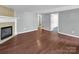 Inviting living room featuring gleaming hardwood floors and a classic fireplace at 11100 Pine Grove Ave, Mint Hill, NC 28227