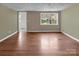Open living area with hardwood floors, neutral walls, and natural light at 11100 Pine Grove Ave, Mint Hill, NC 28227