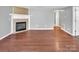 Spacious living room with hardwood floors and a fireplace, perfect for relaxation at 11100 Pine Grove Ave, Mint Hill, NC 28227