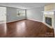 Cozy living room boasts hardwood floors and a fireplace with decorative mantel at 11100 Pine Grove Ave, Mint Hill, NC 28227