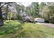 Large grassy yard featuring mature trees and an outbuilding/garage at 11100 Pine Grove Ave, Mint Hill, NC 28227