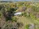 Aerial shot of a home surrounded by lush, mature trees and greenery at 11170 Nc Hwy 73 E Hwy, Mount Pleasant, NC 28124