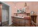 Bathroom with vanity, mirror, sconce, and salmon colored walls at 11170 Nc Hwy 73 E Hwy, Mount Pleasant, NC 28124