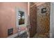 Bathroom with decorative shower, window with view, and salmon colored walls at 11170 Nc Hwy 73 E Hwy, Mount Pleasant, NC 28124