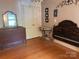 Bedroom with hardwood floors, dresser with mirror, small table, and dark wood headboard at 11170 Nc Hwy 73 E Hwy, Mount Pleasant, NC 28124