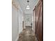 Hallway with slate floors, white door, wooden door on the right, and white cabinet at 11170 Nc Hwy 73 E Hwy, Mount Pleasant, NC 28124