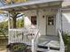 Covered patio with table, chairs, stairs, and white railing at 11170 Nc Hwy 73 E Hwy, Mount Pleasant, NC 28124