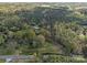 Overhead view captures homes nestled amongst sprawling woodlands and a straight road at 11170 Nc Hwy 73 E Hwy, Mount Pleasant, NC 28124