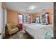 Spacious bedroom with large windows, an armchair, and soft decor creating a relaxing atmosphere at 11170 Nc Hwy 73 E Hwy, Mount Pleasant, NC 28124
