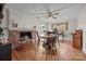 Charming dining room boasts a brick fireplace, wood floors, and a classic round table with chairs at 11170 Nc Hwy 73 E Hwy, Mount Pleasant, NC 28124