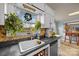 Sunlit kitchen featuring a mosaic backsplash, undermount sink, and verdant plants adorning the window at 11170 Nc Hwy 73 E Hwy, Mount Pleasant, NC 28124