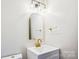 A stylish bathroom with a modern vanity, arched mirror, and gold fixtures at 1162 Westover Cir, Rock Hill, SC 29732