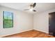 Well-lit bedroom with a modern ceiling fan and a large window overlooking the outdoors at 1162 Westover Cir, Rock Hill, SC 29732