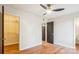 Bedroom with hardwood floors, closet, and a ceiling fan, designed for relaxation and convenience at 1162 Westover Cir, Rock Hill, SC 29732