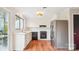 A modern kitchen with white cabinets, stainless steel appliances, and a view to an outdoor seating area at 1162 Westover Cir, Rock Hill, SC 29732