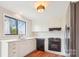 A well-lit kitchen featuring white cabinets, modern appliances, wood floors, and a view to the outside at 1162 Westover Cir, Rock Hill, SC 29732