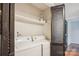 Laundry room featuring a washing machine and dryer, with black bi-fold doors at 1162 Westover Cir, Rock Hill, SC 29732
