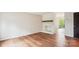 Open living room featuring hardwood floors and a brick fireplace with modern slider door at 1162 Westover Cir, Rock Hill, SC 29732