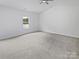 Spacious bedroom with neutral carpet, a ceiling fan, and a window providing natural light at 1235 Culver Spring Way, Charlotte, NC 28215