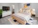 Stylishly staged bedroom with a minimalist design, featuring a comfortable bed and ample natural light at 1235 Culver Spring Way, Charlotte, NC 28215
