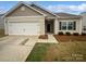 Charming single-story home featuring a two-car garage, neutral siding, and well-maintained landscaping at 1235 Culver Spring Way, Charlotte, NC 28215