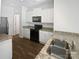 Well-lit kitchen with white cabinets, granite countertops, and modern black appliances at 1235 Culver Spring Way, Charlotte, NC 28215