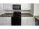 Modern kitchen featuring white cabinetry, granite counters, and black appliances at 1235 Culver Spring Way, Charlotte, NC 28215