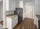 Open kitchen showcasing white cabinets, granite countertops, and stainless steel refrigerator at 1235 Culver Spring Way, Charlotte, NC 28215