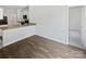 Open-concept living space with wood flooring transitioning to a view of the kitchen and adjoining rooms at 1235 Culver Spring Way, Charlotte, NC 28215