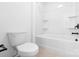Well-lit bathroom featuring a toilet, bathtub-shower combination, and neutral flooring at 12437 Walker Dr # 89, Stanfield, NC 28163