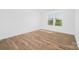 Bedroom with hardwood floors and a large window showcasing the community at 12437 Walker Dr # 89, Stanfield, NC 28163