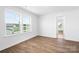 Bright bedroom boasts wood-look floors and large windows overlooking the pleasant outdoors at 12437 Walker Dr # 89, Stanfield, NC 28163