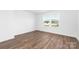 Bright bedroom features beautiful wood-look floors and large windows to let the sunshine in at 12437 Walker Dr # 89, Stanfield, NC 28163