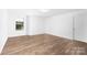 Bedroom with hardwood floors and a window with a view of the community at 12437 Walker Dr # 89, Stanfield, NC 28163